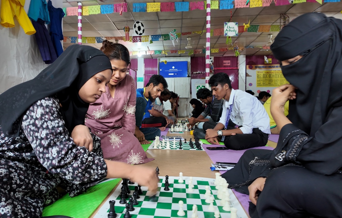 参与项目的女孩在棋盘前学习。